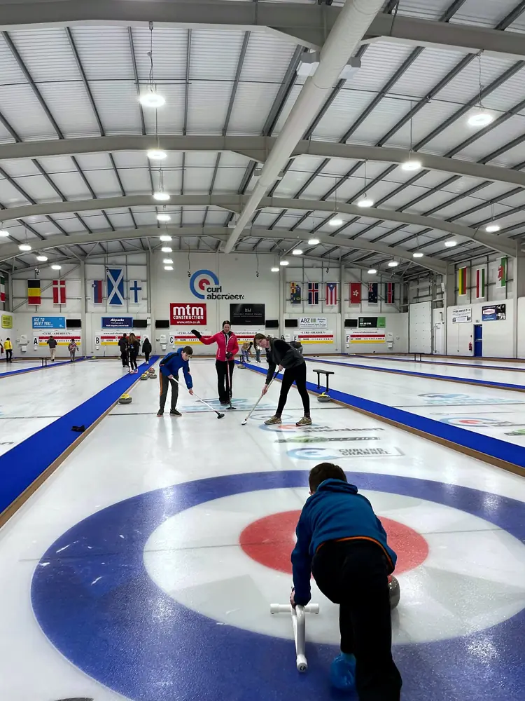 A junior curler on the ice