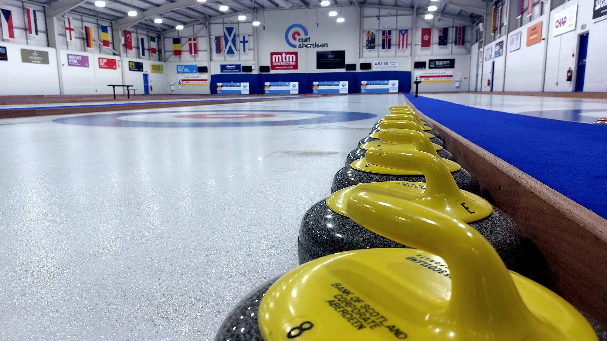 A yellow-handled stone on the ice